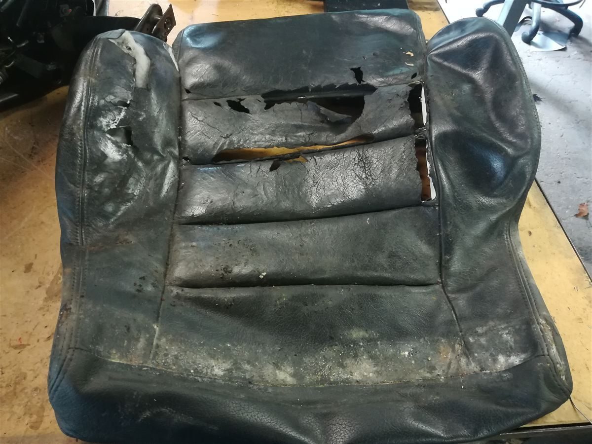 Damaged leather seat before restoration